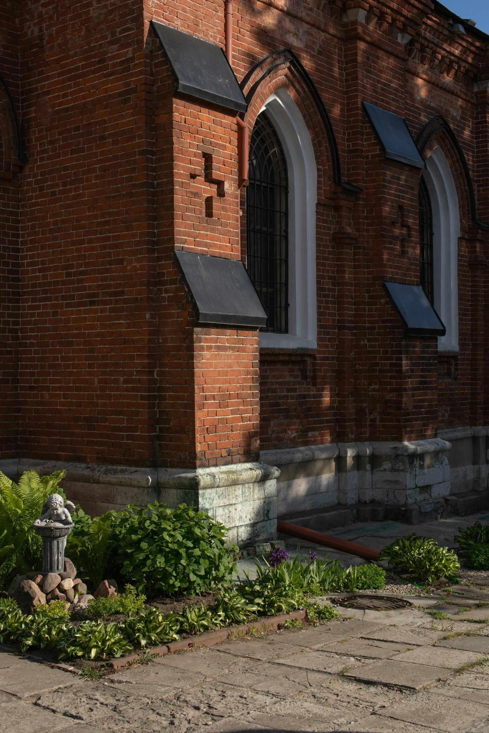 brick building with a stone statue in front of it